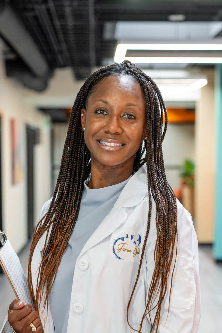 Smiling woman in a white lab coat.
