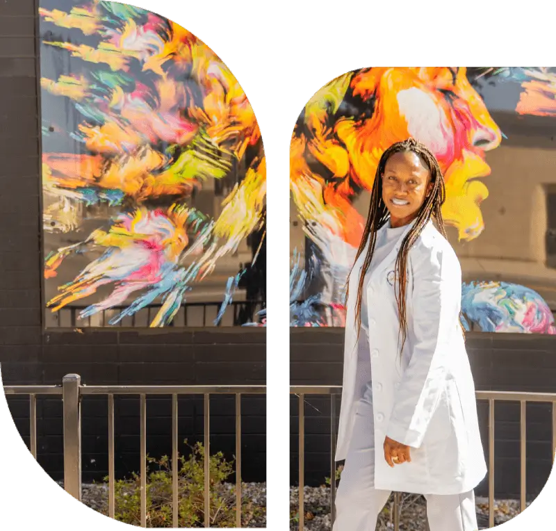 Person in white coat, colorful mural background.