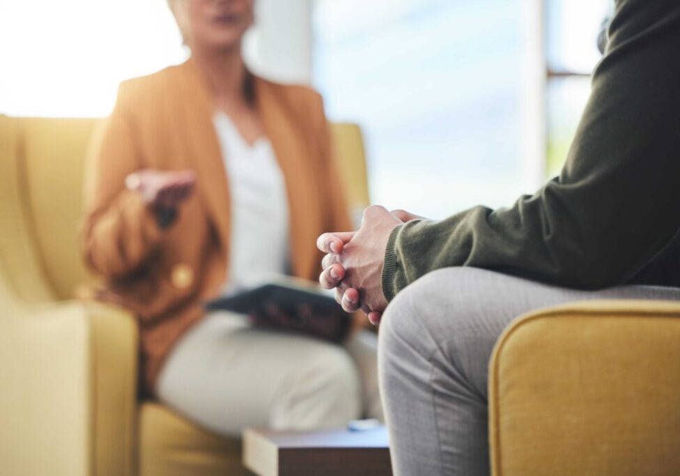 Two people talking in a counseling session.